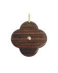 Pendentif croix en or et nacre de Maison Labrune, avec détail en bois, porté sur un collier élégant.