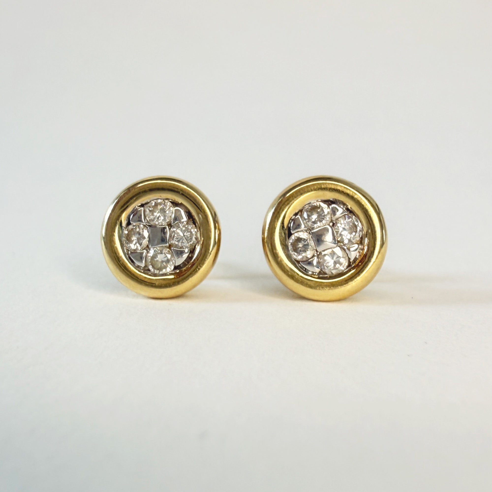 Paire de clous d’oreilles en or jaune 18 carats sertis de quatre diamants taille brillant, bijoux élégants et intemporels, parfaits pour un style chic et raffiné.