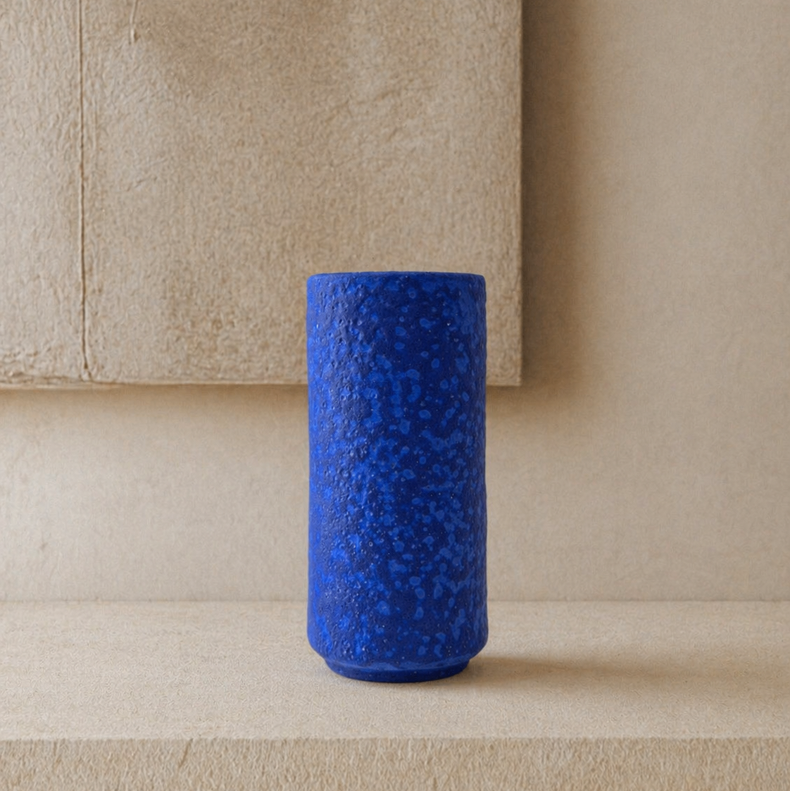 vase en céramique vintage bleu klein à effet fat lava sur un fond neutre ambiance natural